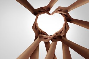 Several people's hands forming a heart shape